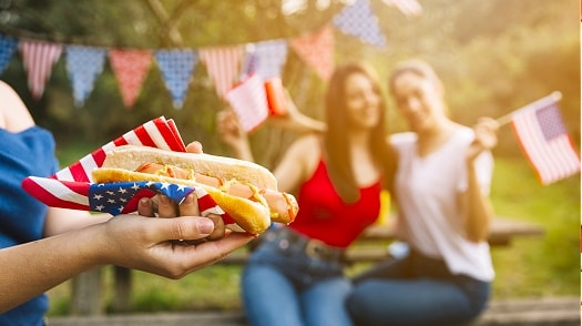 American Independence day party people flags anf hotdogs.