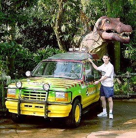 Paul Denton with dinosaur at Jurassic Park